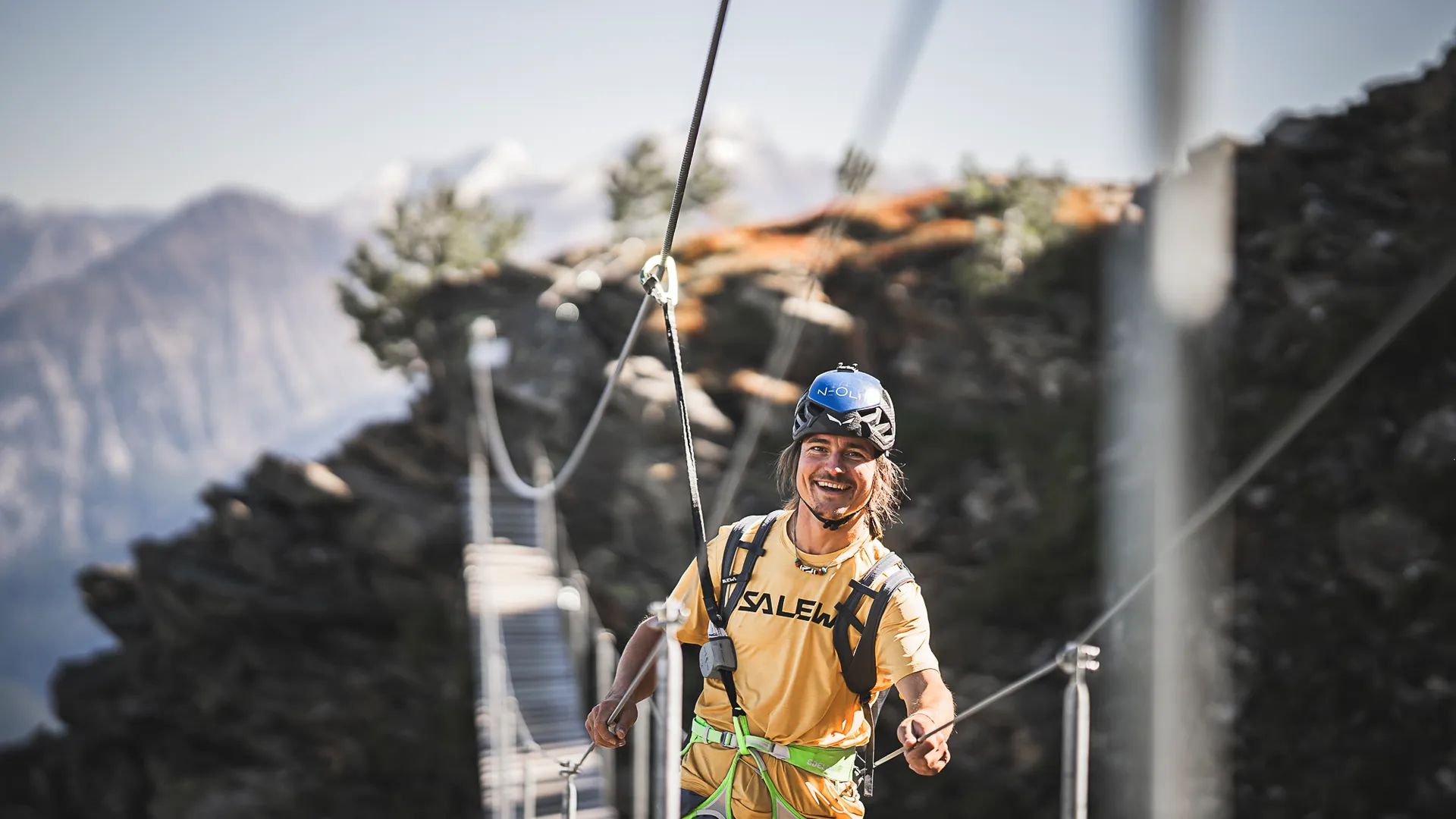 Junger Kletterer auf Hängebrücke am Klettersteig Klausberg mit Blick auf die Tauern