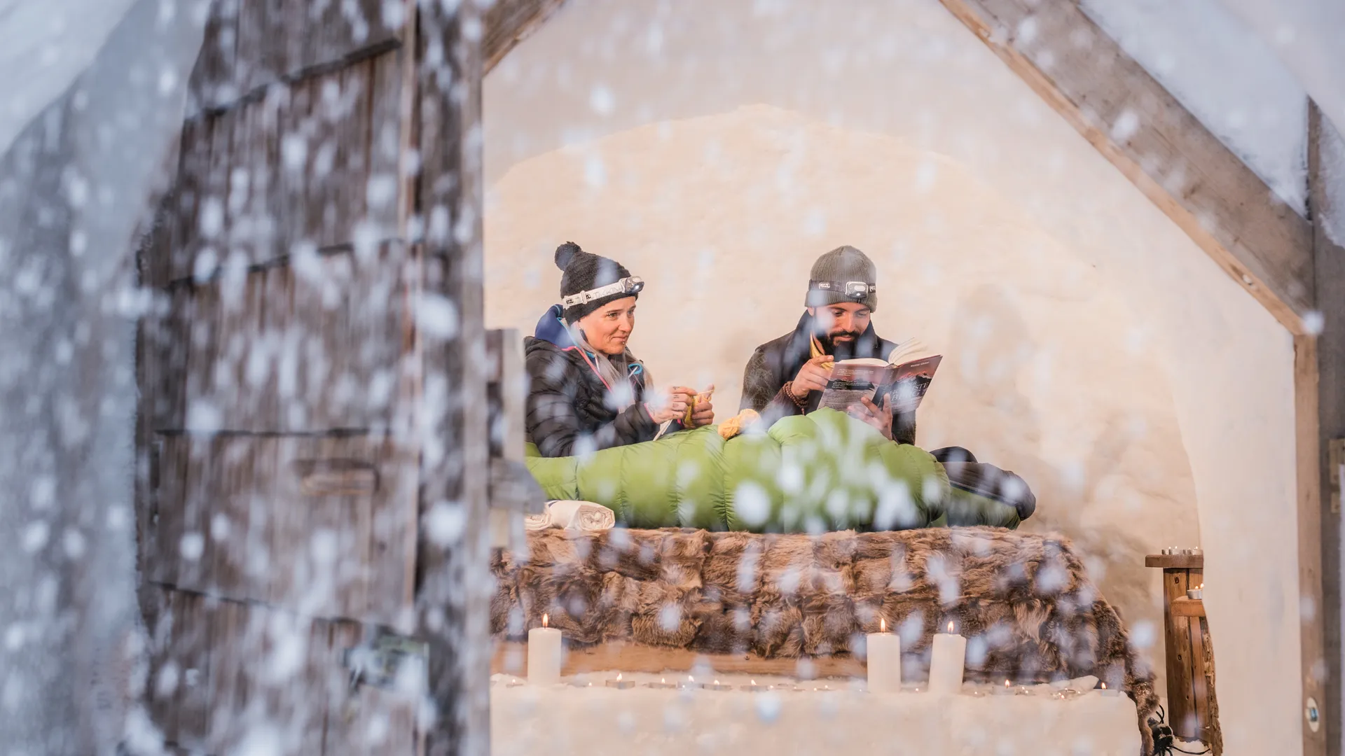 Romantic igloo night in Ahrntal – couple in a snow igloo with candles and headlamps