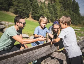 Family explores a nature station together at the adventure mountain in Ahrntal