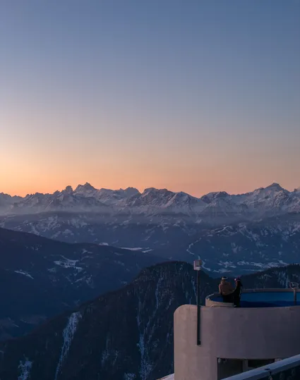 Sunrise over the Dolomites with two people on the viewing platform at Klausberg