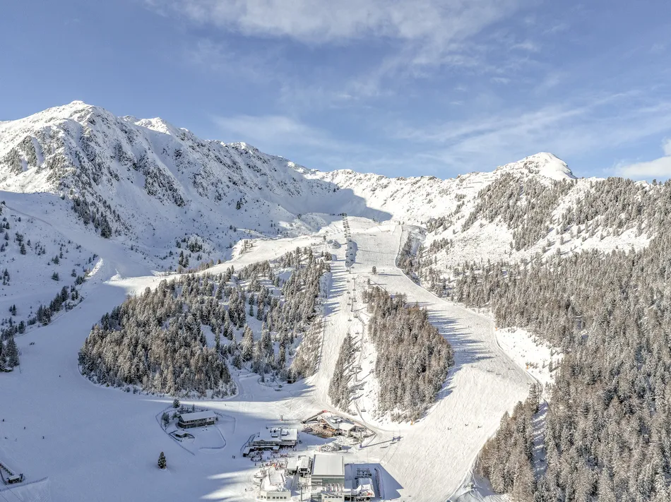 Aerial view of Speikboden ski slopes with valley station and snowy mountain scenery in Ahrntal